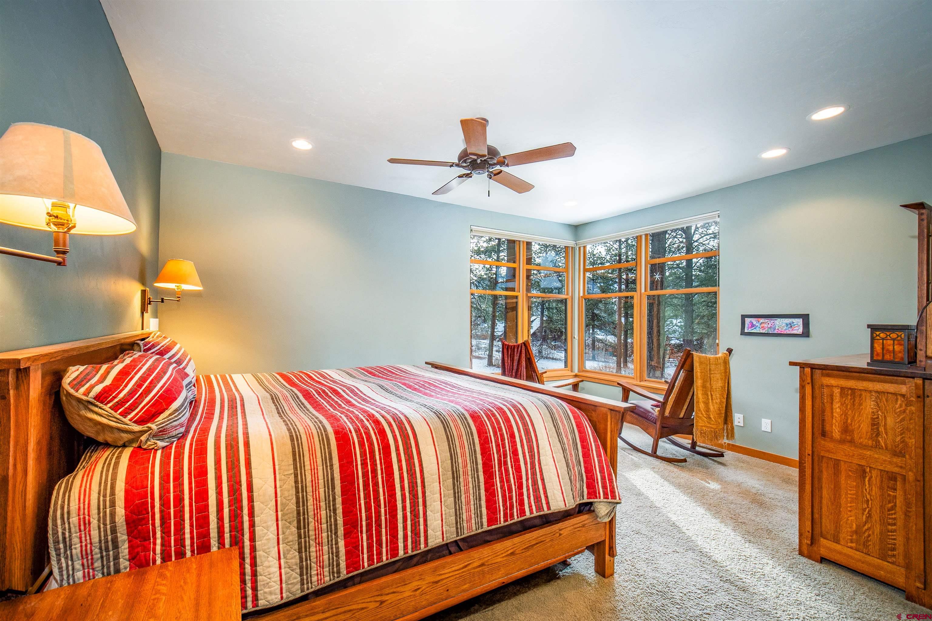 25 Red Table Court Durango, CO 81301 - Photo 10 of 34 a bedroom with a bed and a chandelier