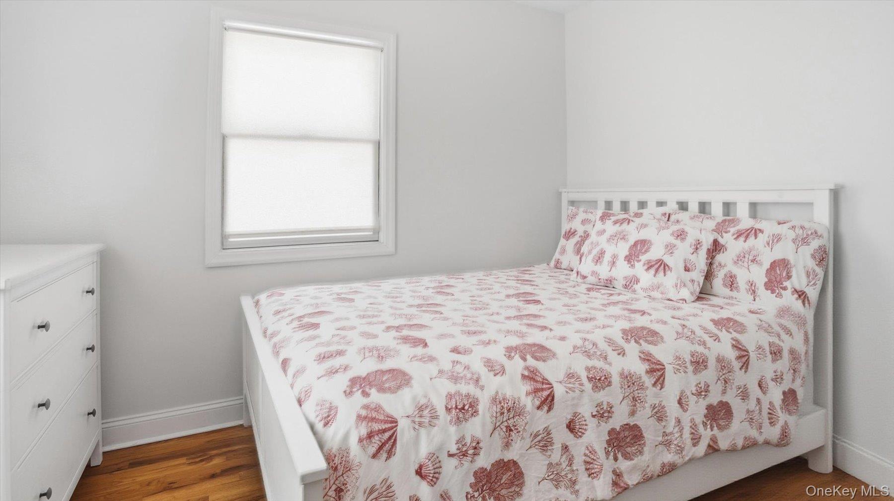 32 Red Creek Road Hampton Bays, NY 11946 - Photo 12 of 20 a bedroom with a bed and a window