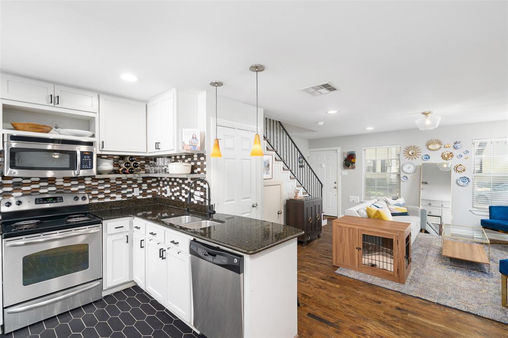 a kitchen with stainless steel appliances kitchen island wooden cabinets and stove top oven