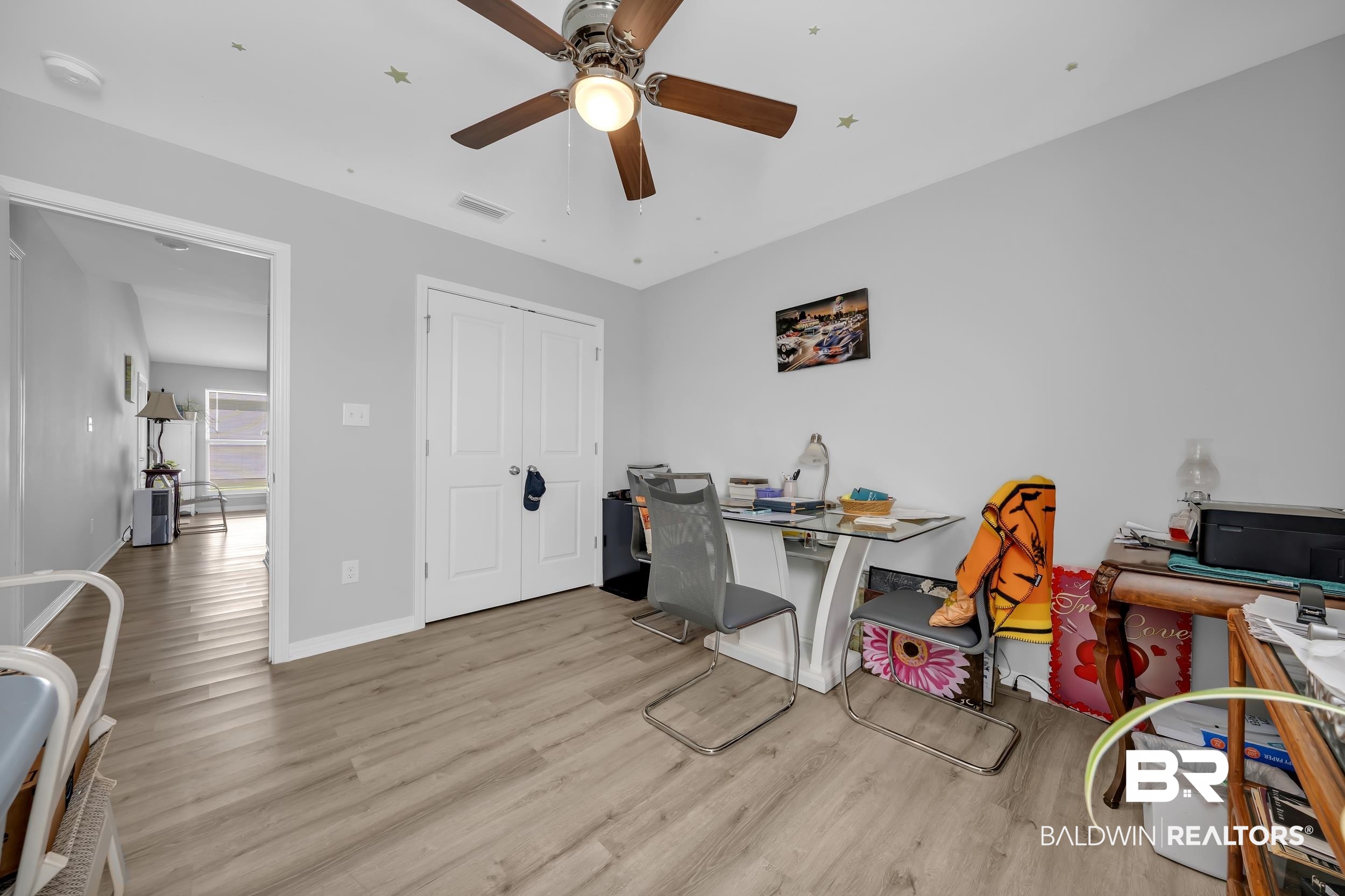 1228 Caper Avenue Foley, AL 36535 - Photo 24 of 54 Room featuring light wood-finish flooring, light gray walls, and white trim