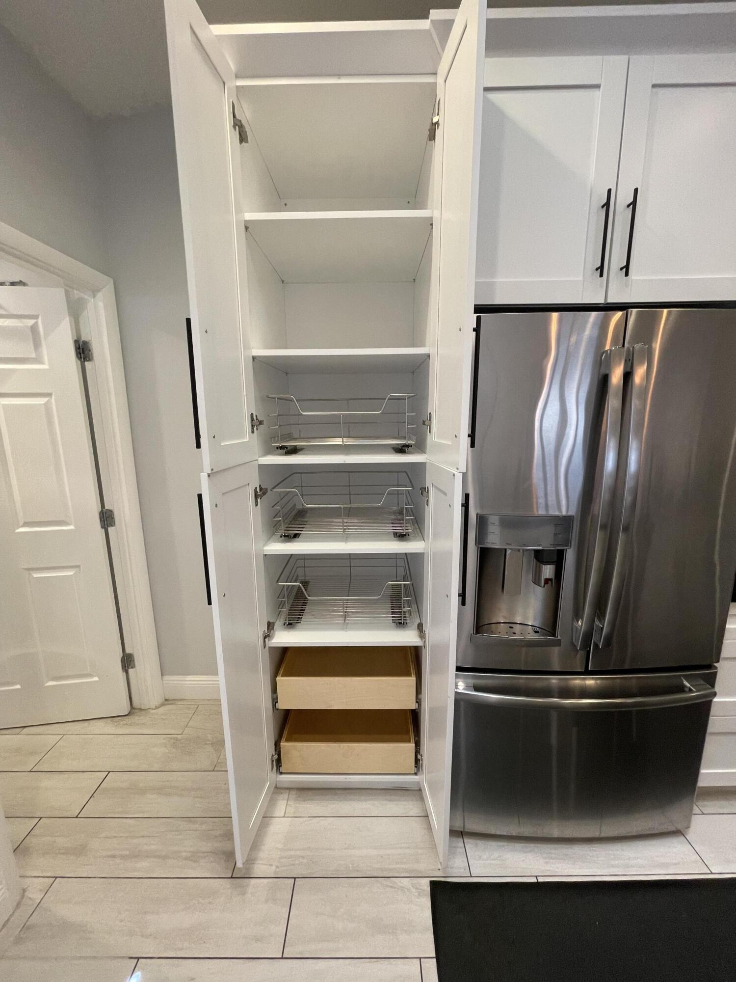 6157 Sunny Pointe Circle Delray Beach, FL 33484 - Photo 12 of 64 a view of washer and dryer with wooden floor