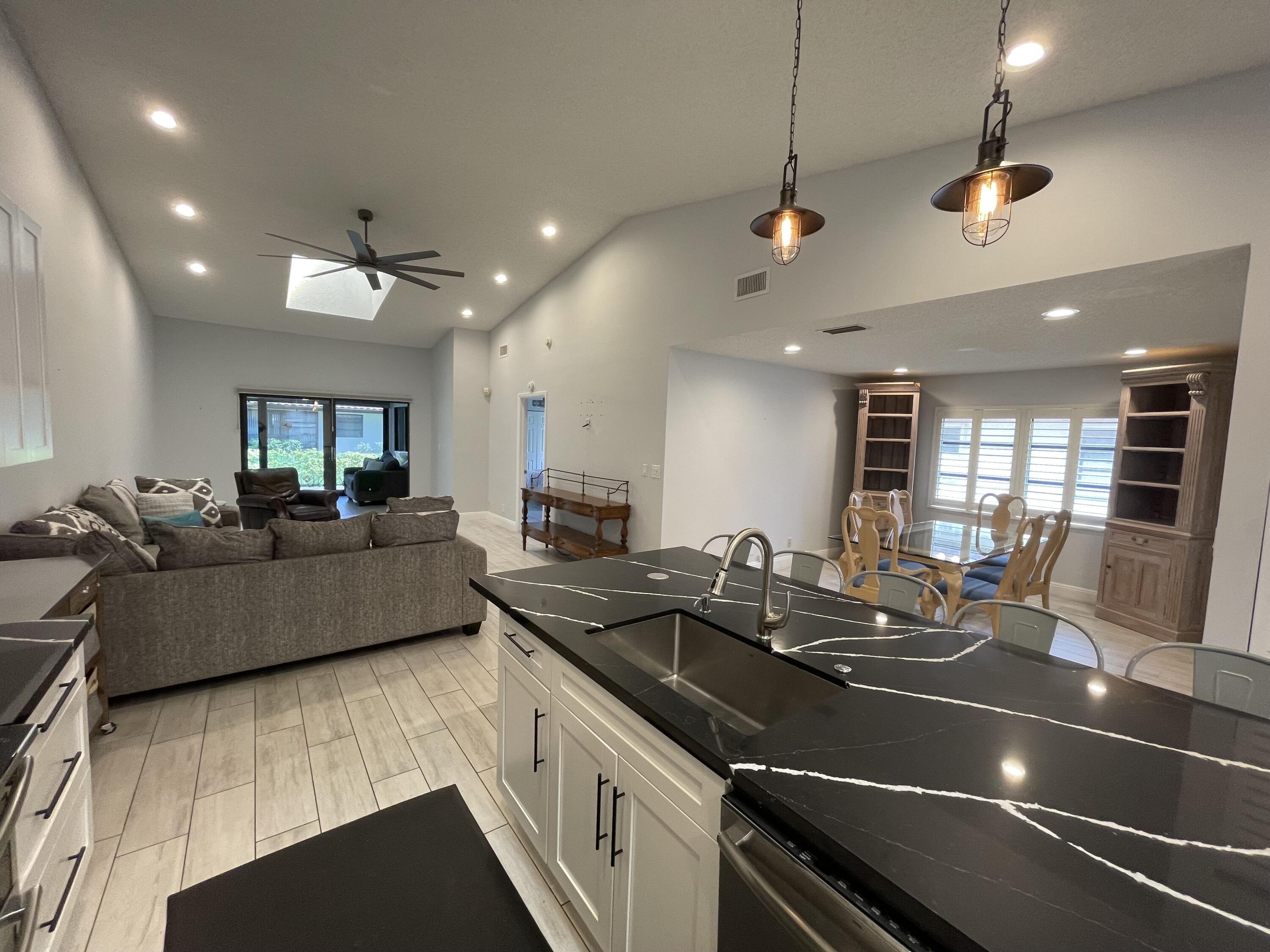 6157 Sunny Pointe Circle Delray Beach, FL 33484 - Photo 13 of 64 a kitchen with counter top space a sink and appliances