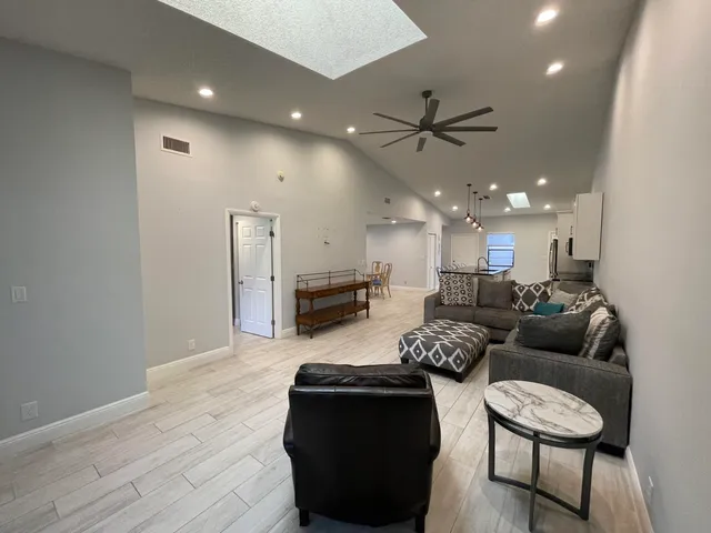 a large white kitchen with a stove a sink dishwasher and a microwave oven