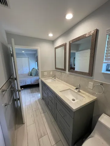 a bedroom with a bed and a mirror