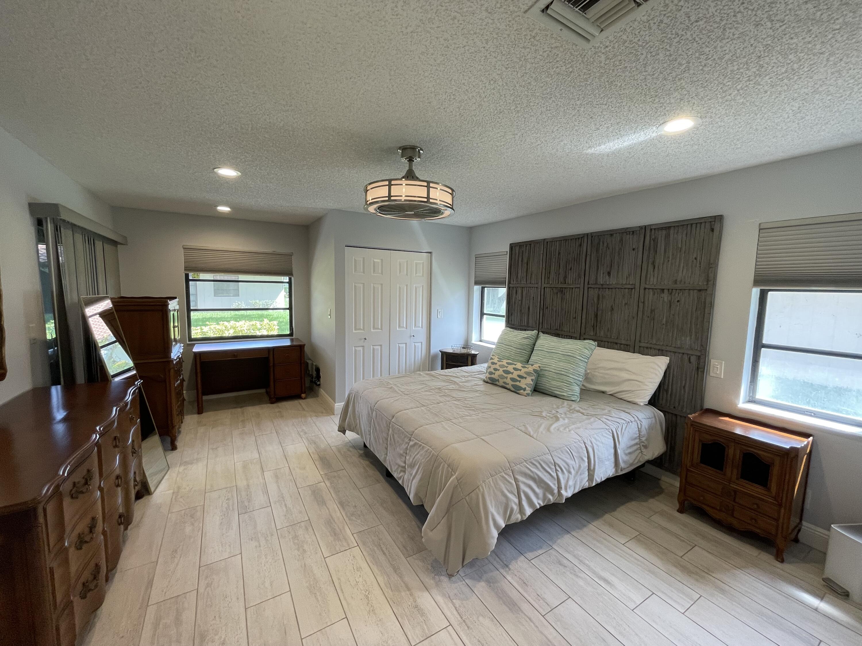 6157 Sunny Pointe Circle Delray Beach, FL 33484 - Photo 20 of 64 a bedroom with a bed and a tv