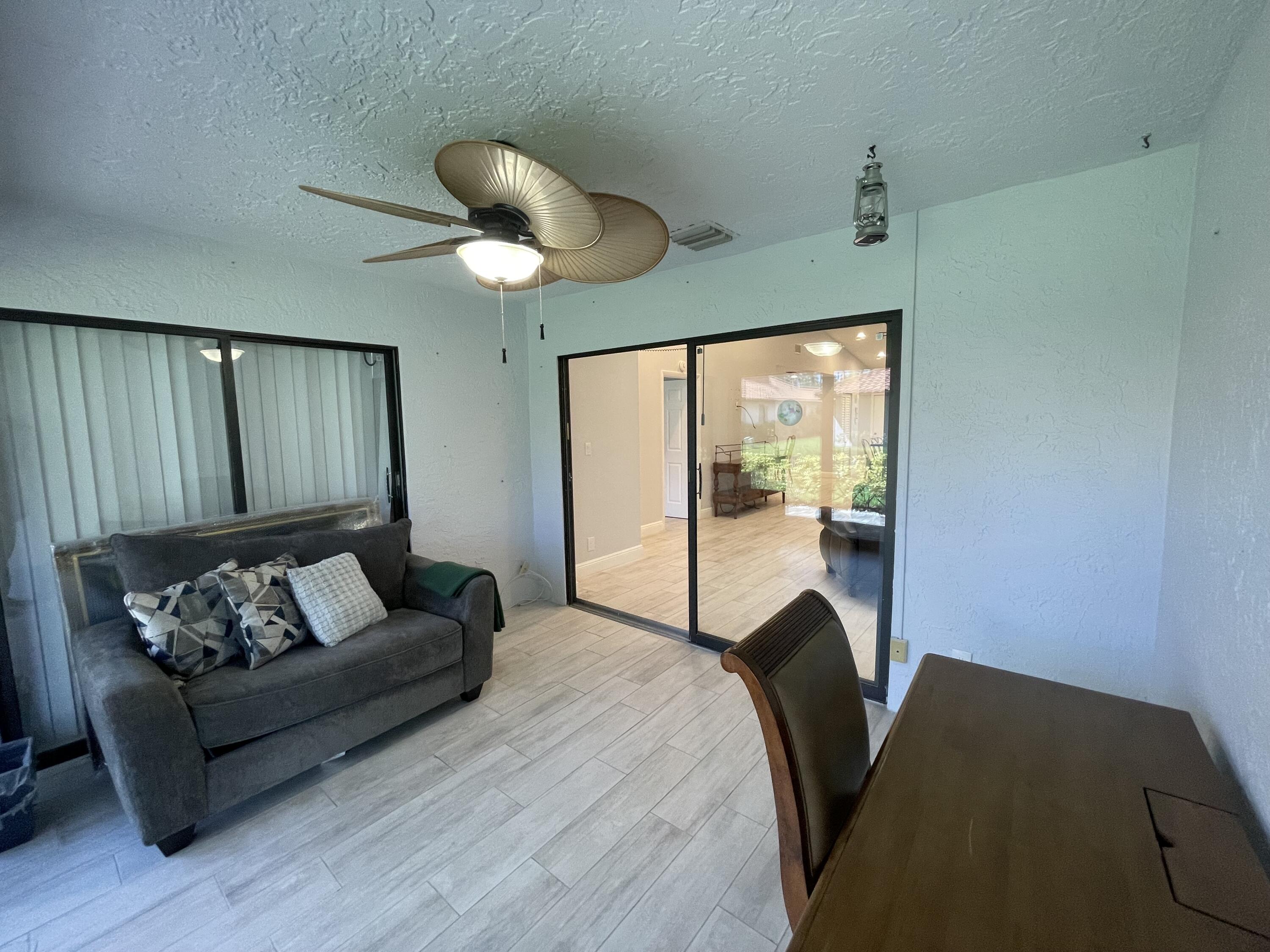 6157 Sunny Pointe Circle Delray Beach, FL 33484 - Photo 34 of 64 a living room with furniture and a large window