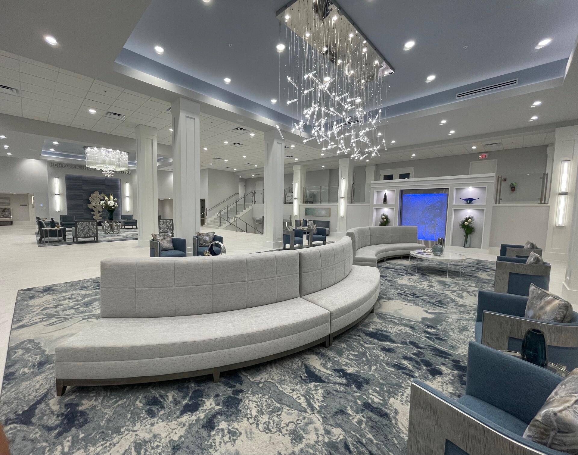 6157 Sunny Pointe Circle Delray Beach, FL 33484 - Photo 43 of 64 a living room with furniture and a chandelier