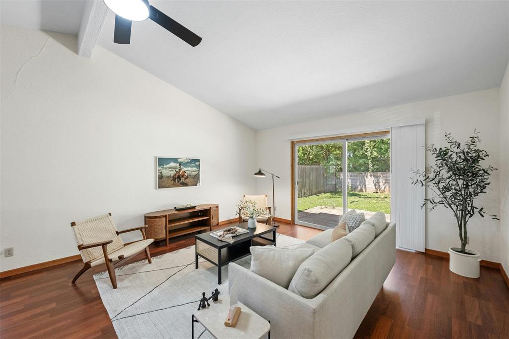 4610 South 1st Street Austin, TX 78745 - Photo 2 of 23 Living room featuring wood finished floors, baseboards, and a ceiling fan
