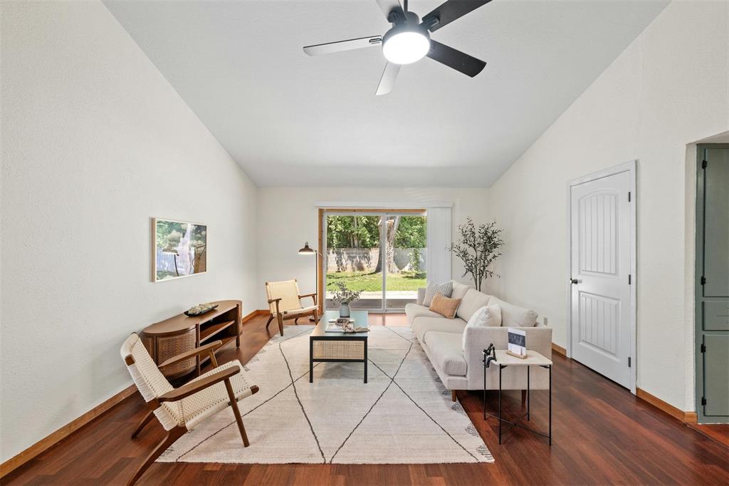 4610 South 1st Street Austin, TX 78745 - Photo 3 of 23 Living room featuring wood finished floors, ceiling fan, baseboards, and high vaulted ceiling