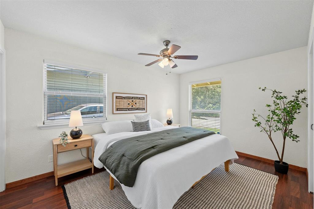 4610 South 1st Street Austin, TX 78745 - Photo 7 of 23 Bedroom featuring baseboards, wood finished floors, and a ceiling fan