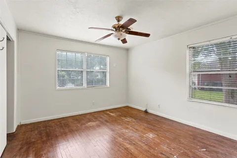 a very nice looking space with wooden floor and a chandelier