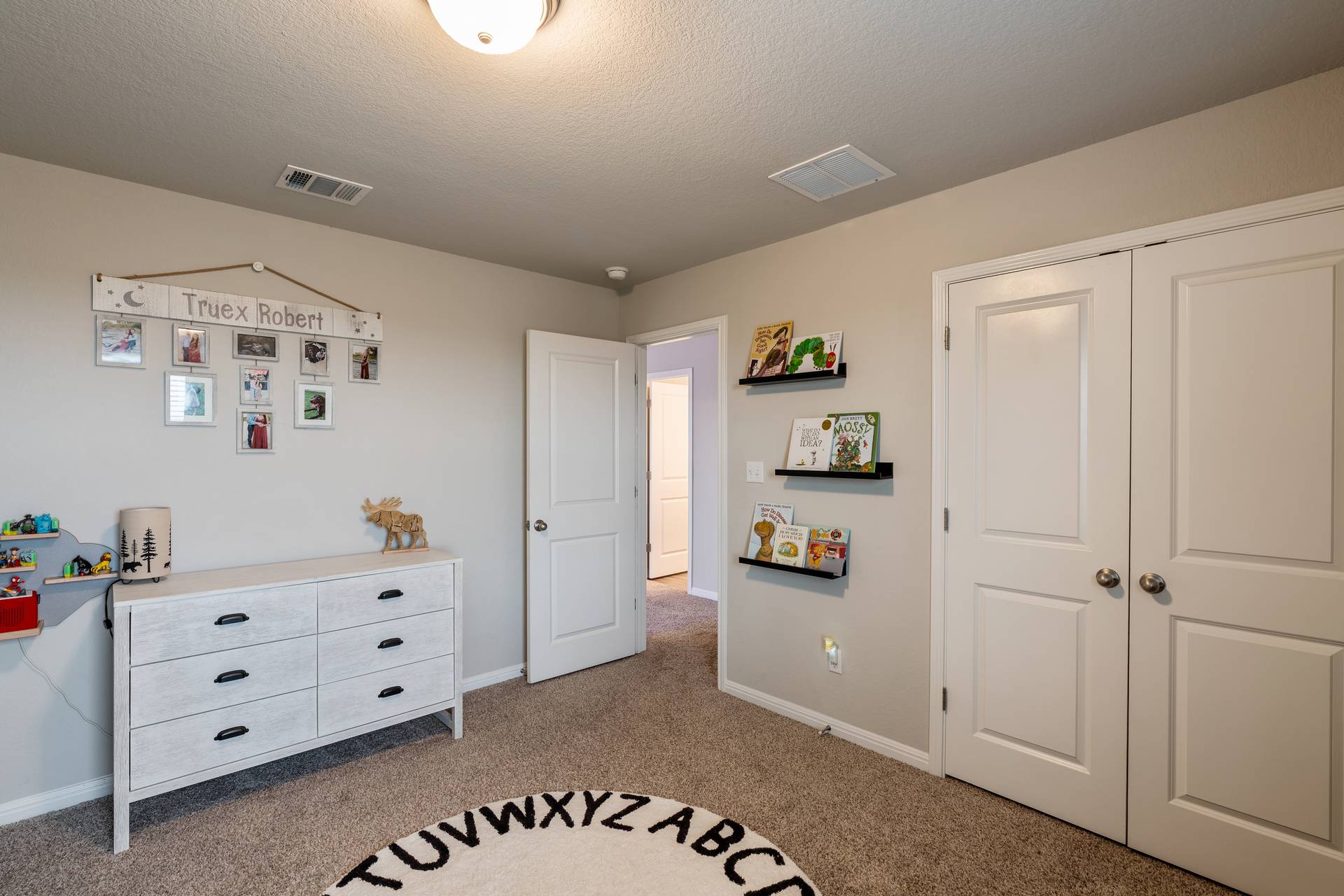 331 Mountain Valley Street Georgetown, TX 78628 - Photo 24 of 40 Bedroom 1 featuring carpet, a closet, and a textured ceiling