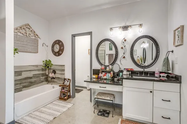 a living room with a mirror and a large window