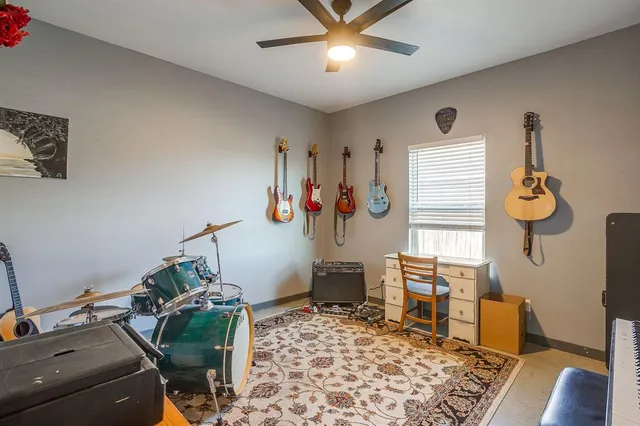 a bathroom with a granite countertop toilet sink and mirror