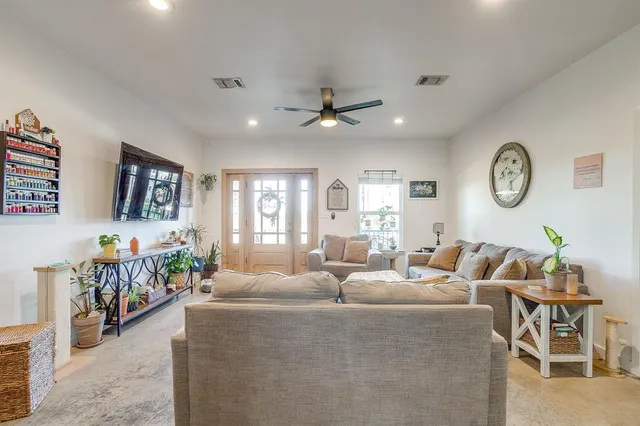 a living room with furniture and a large window