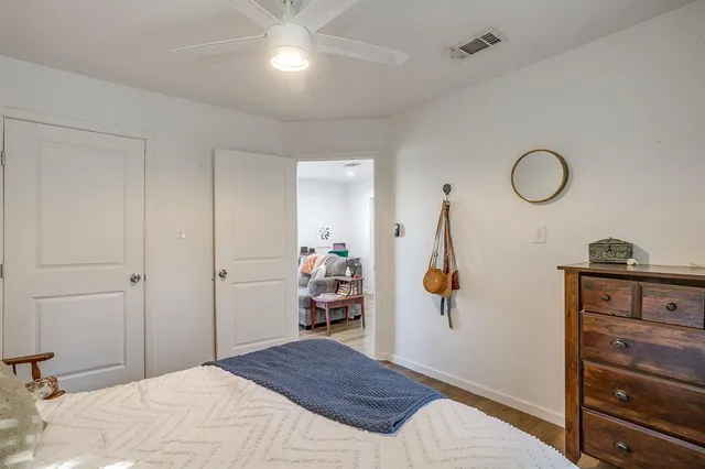 a bedroom with a bed and a painting on the wall