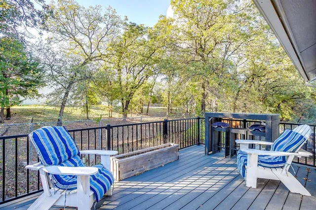 a view of a chairs and table on the balcony