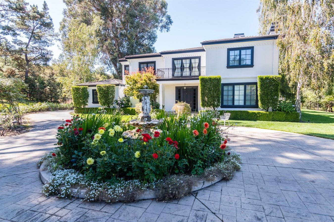 a front view of a house with garden