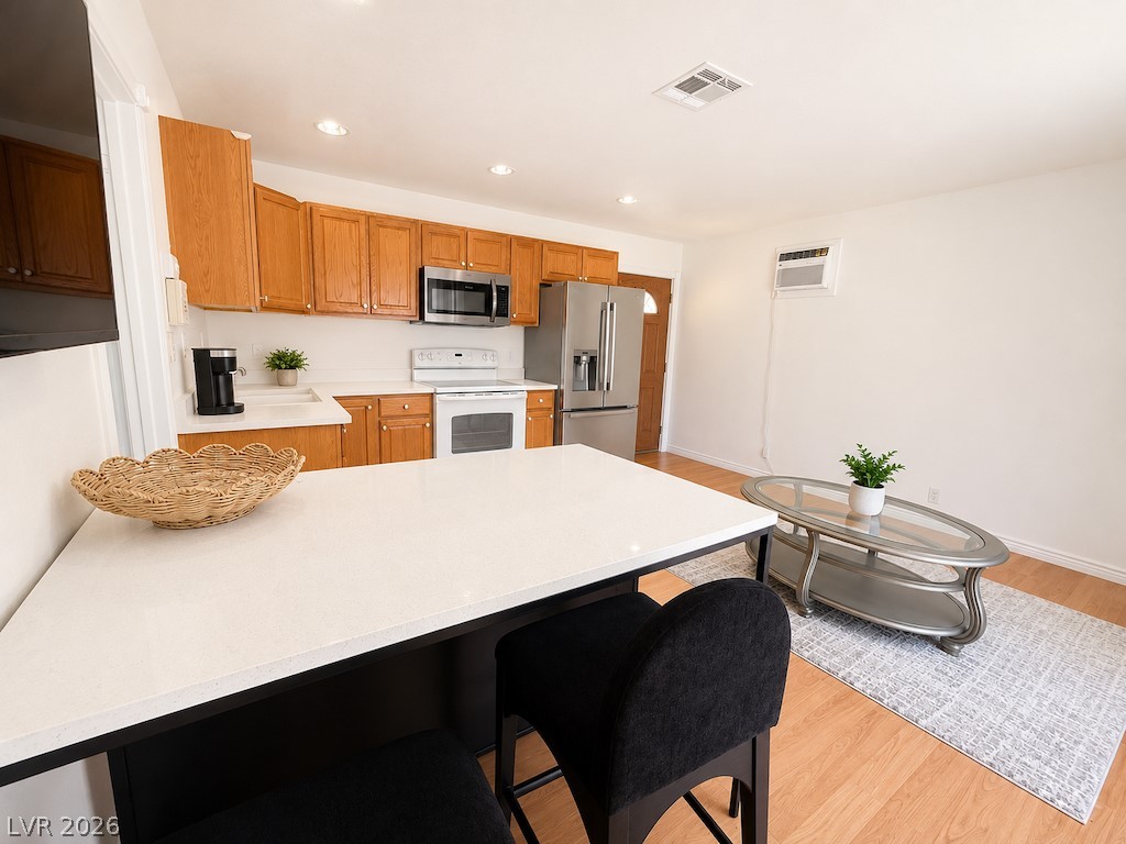 3010 East Viking Road Las Vegas, NV 89121 - Photo 34 of 48 A well-appointed kitchen flows into an inviting living space with bright wood flooring.