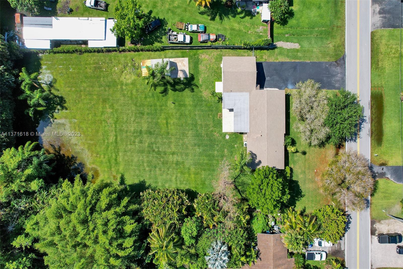 4930 Southwest 188th Avenue Southwest Ranches, FL 33332 - Photo 31 of 33 an aerial view of a house with a yard lake and green space