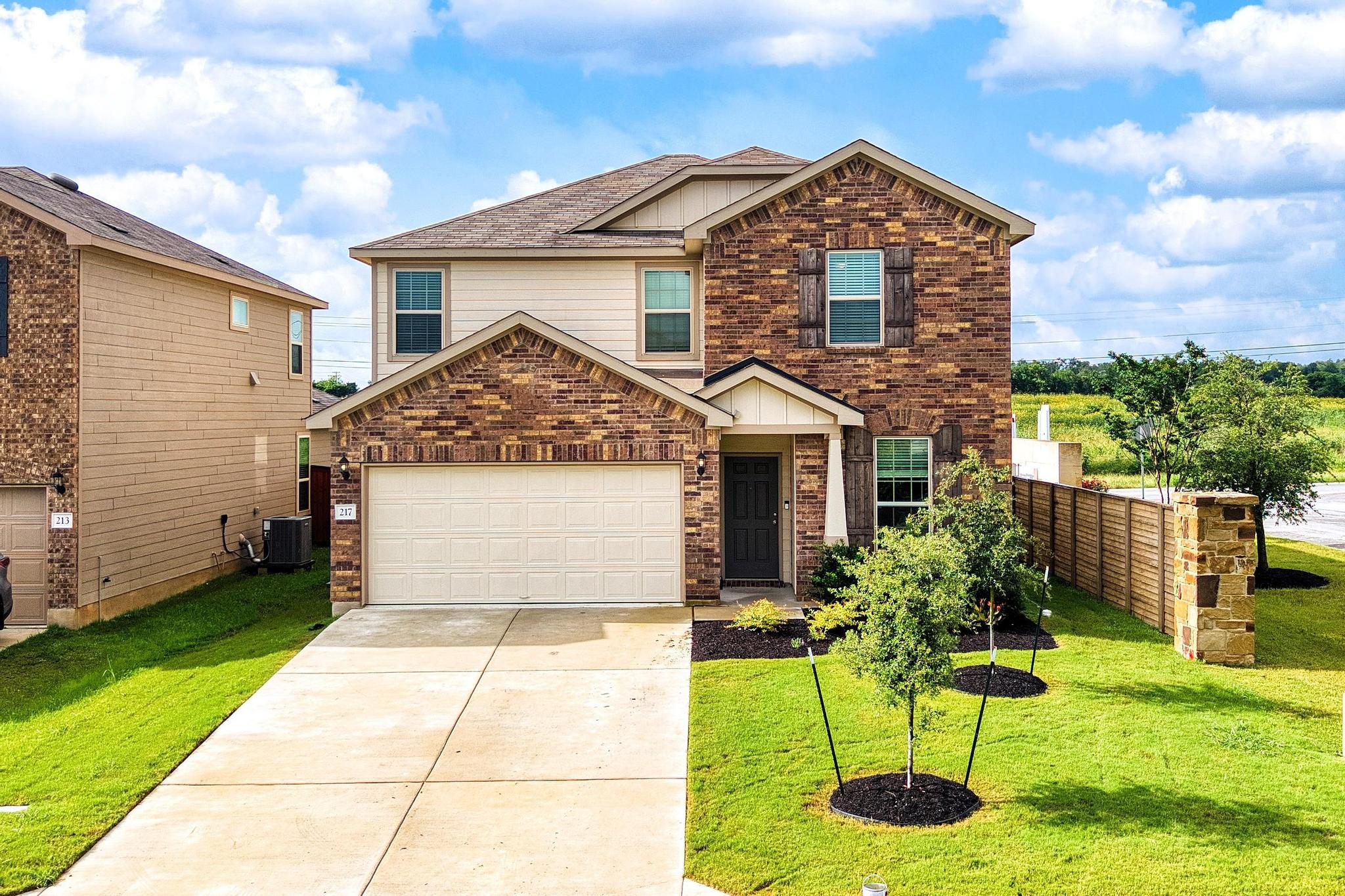 217 Innisfree Road Jarrell, TX 76537 - Photo 1 of 39 Front of the house features front entry 2 car garage.