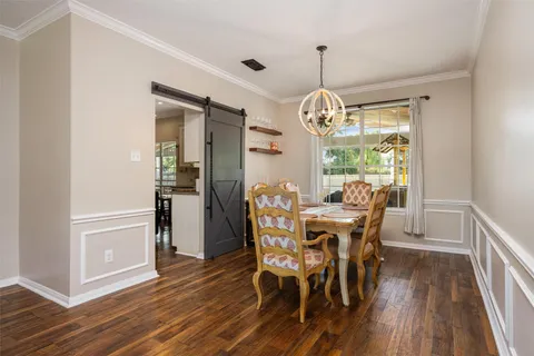 a view of a dining room with furniture wooden floor and chandelier
