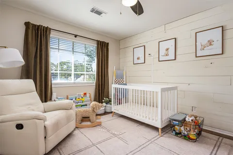 a utility room with dryer washer and a view of bedroom