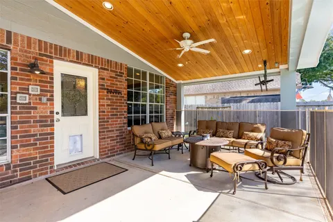 a backyard of a house with table and chairs