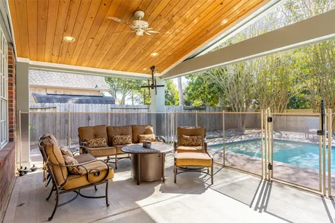 a view of a backyard with swimming pool