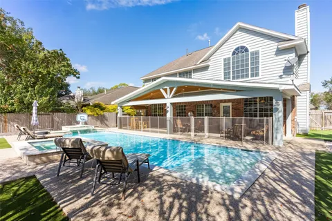 a view of a house with swimming pool and sitting area