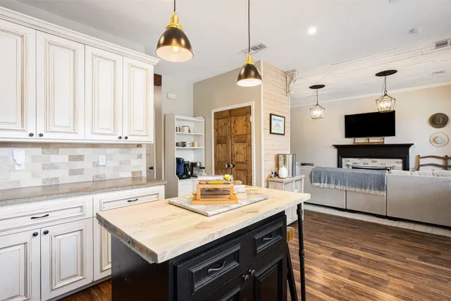 a view of a dining room with furniture wooden floor and chandelier