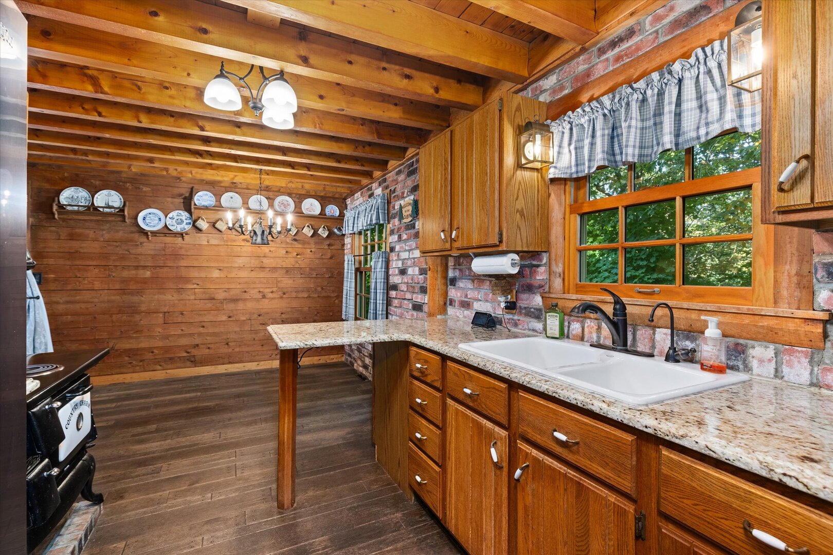 910 Durant Street Oglesby, IL 61348 - Photo 14 of 52 a kitchen with stainless steel appliances granite countertop a sink a stove and a wooden floor