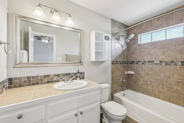 a bathroom with a sink a toilet and a bathtub