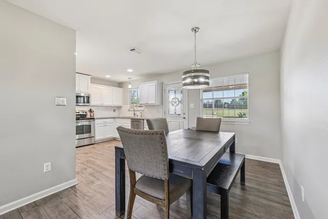 a view of a dining room with furniture window and wooden floor