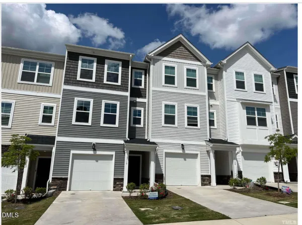 a front view of a residential apartment building with a yard