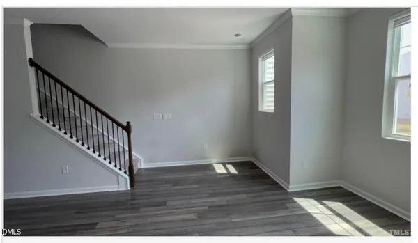 a view of an entryway with wooden floor