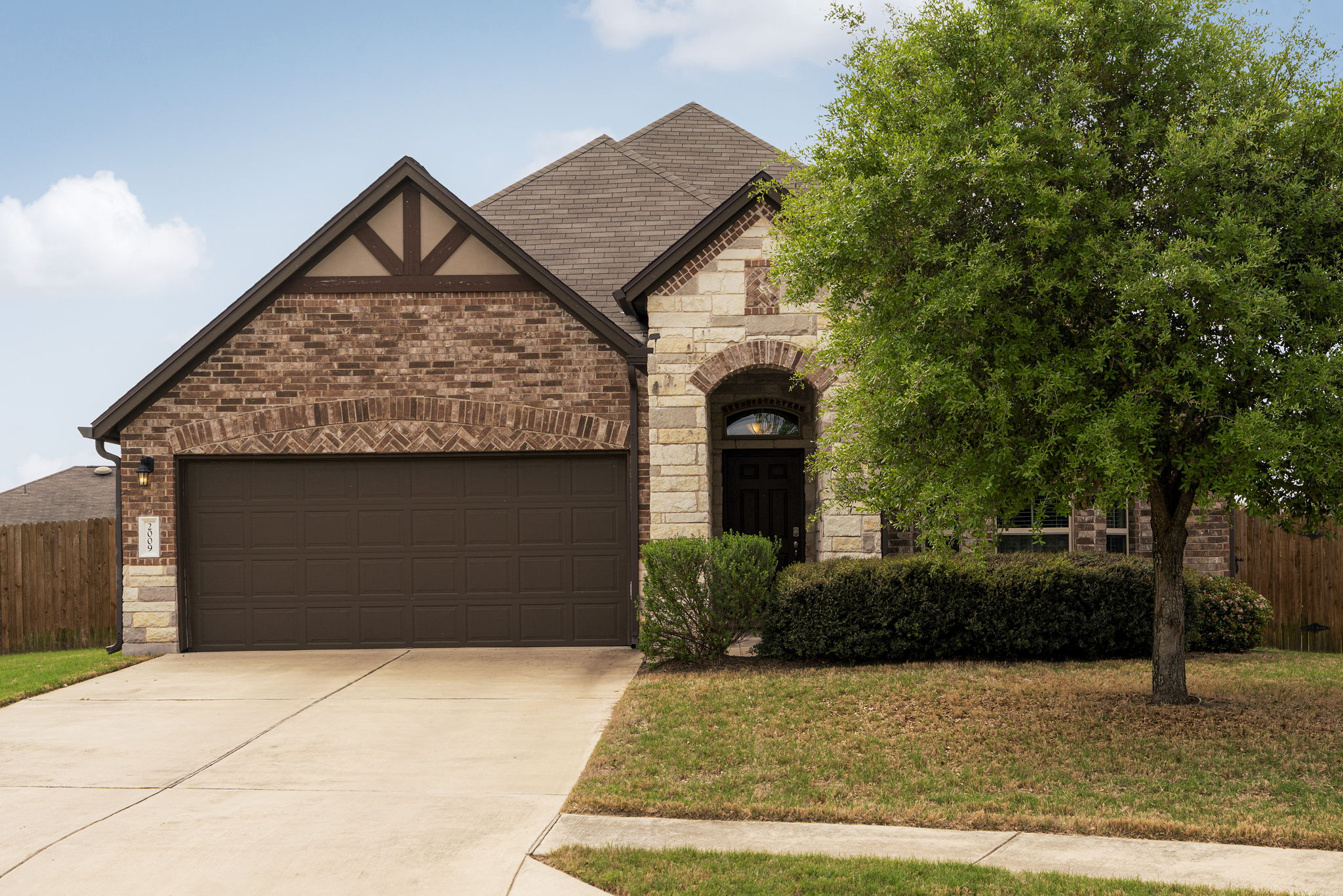 2009 Kates Cove Manchaca, TX 78652 - Photo 1 of 25 a front view of a house with garden