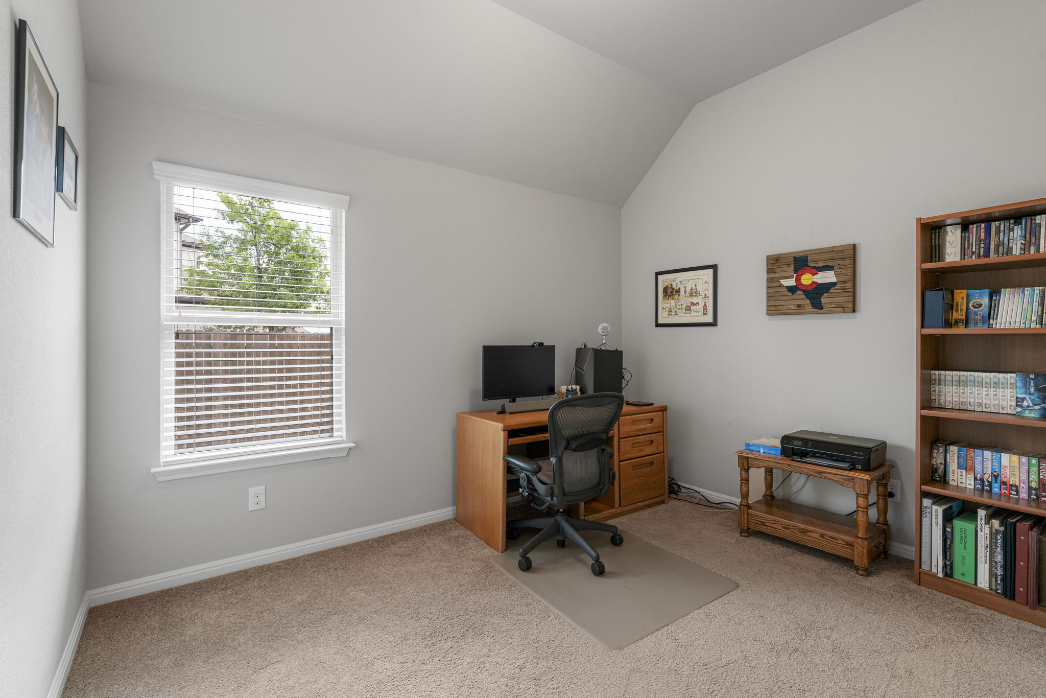2009 Kates Cove Manchaca, TX 78652 - Photo 13 of 25 a view of a workspace with a window and a bookshelf