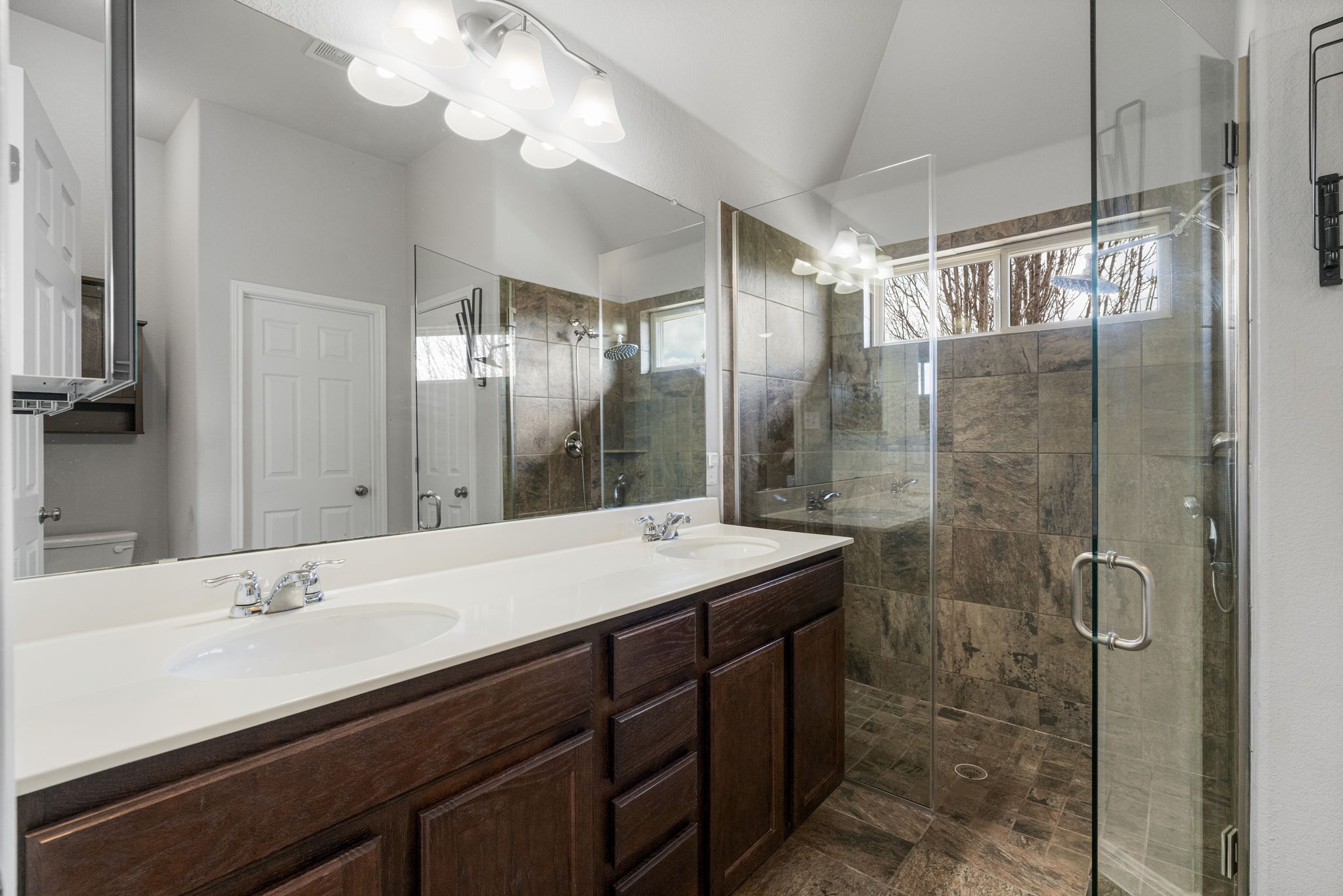 2009 Kates Cove Manchaca, TX 78652 - Photo 17 of 25 a bathroom with a double vanity sink mirror and shower