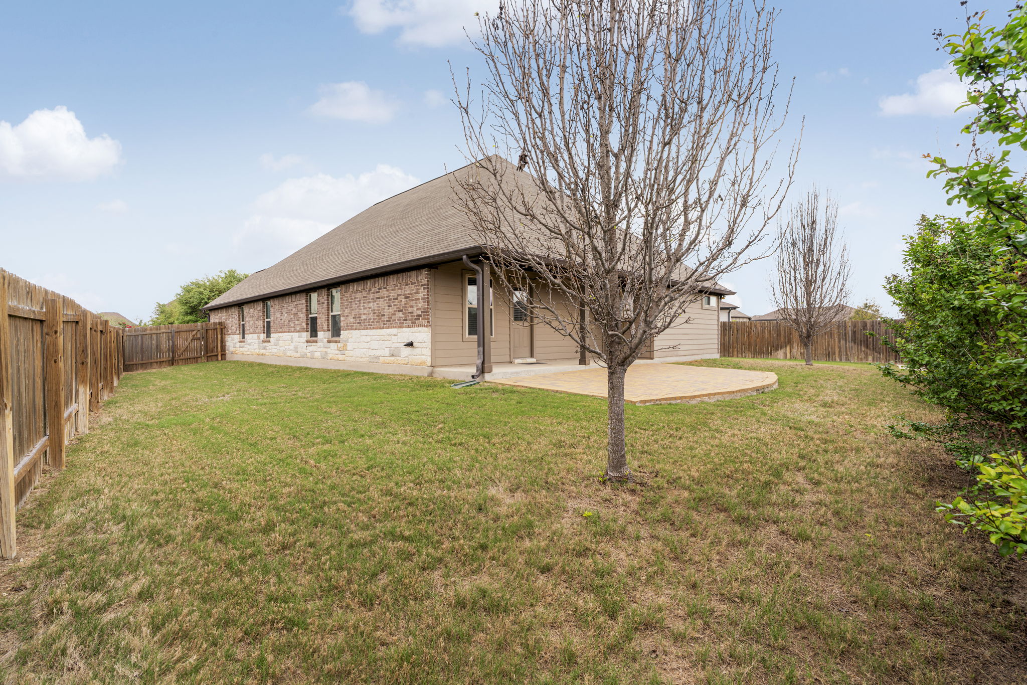2009 Kates Cove Manchaca, TX 78652 - Photo 21 of 25 a view of a house with backyard and tree