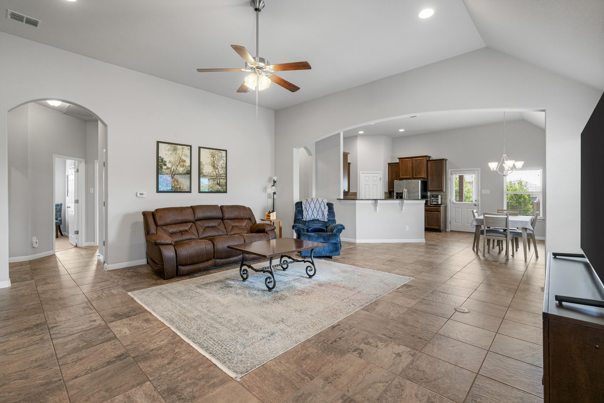 2009 Kates Cove Manchaca, TX 78652 - Photo 5 of 25 a living room with furniture and a dining table with kitchen view