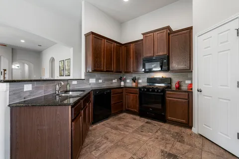 a view of a dining room with furniture and chandelier