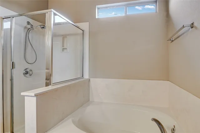 a bathroom with a bathtub and shower