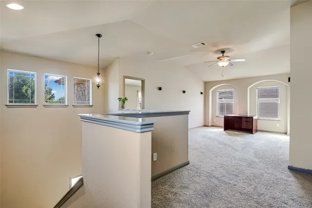 a view of a kitchen with a sink cabinet and a living room view