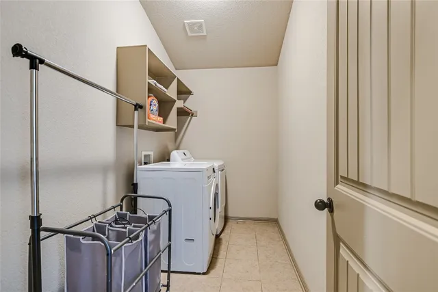 a view of storage and utility room with washer and dryer