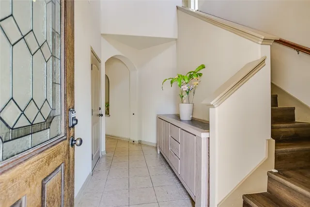 a hallway with sink and cabinets