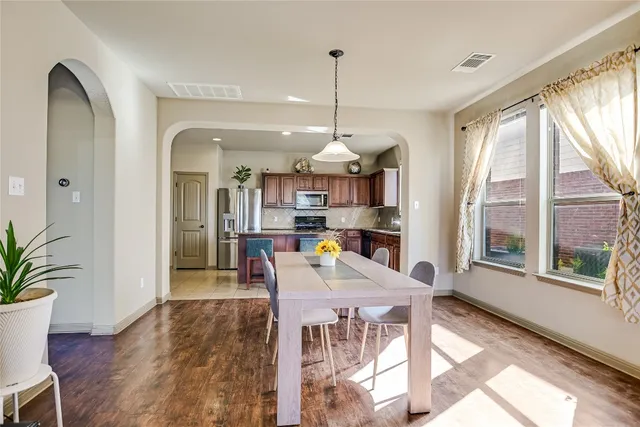 a view of a dining room with furniture window and wooden floor