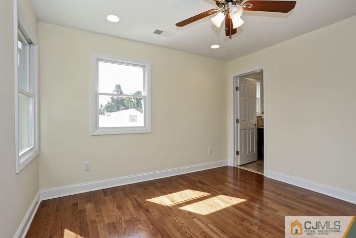 8 High Point Road East Brunswick, NJ 08816 - Photo 14 of 16 a view of an empty room with window and wooden floor