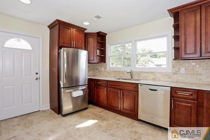 8 High Point Road East Brunswick, NJ 08816 - Photo 3 of 16 a kitchen with stainless steel appliances granite countertop a refrigerator and a sink