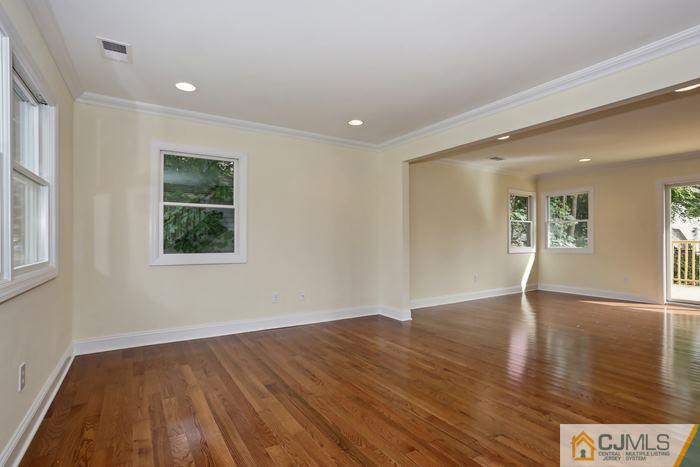 8 High Point Road East Brunswick, NJ 08816 - Photo 8 of 16 a view of an empty room with wooden floor and a window
